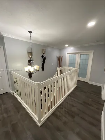 a bedroom with bed window and mirror