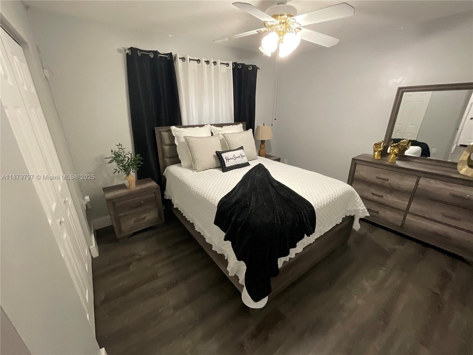 9710 Southwest 13th Street, Unit 9710 Pembroke Pines, FL 33025 - Photo 22 of 43 a bedroom with a bed and a mirror