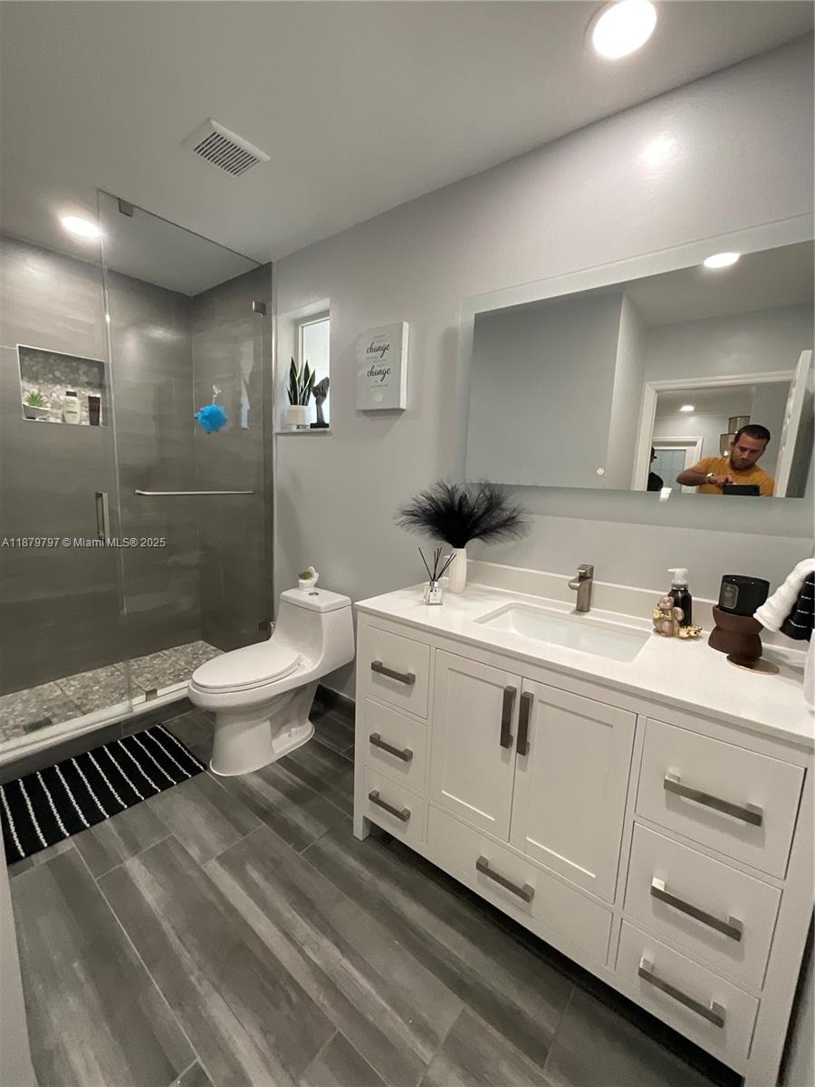 9710 Southwest 13th Street, Unit 9710 Pembroke Pines, FL 33025 - Photo 25 of 43 a bathroom with a sink double vanity granite and a toilet