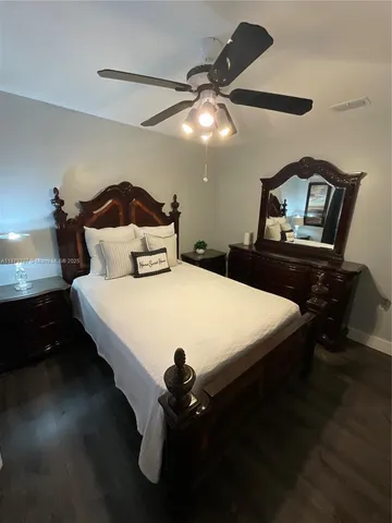 a bedroom with furniture and a chandelier