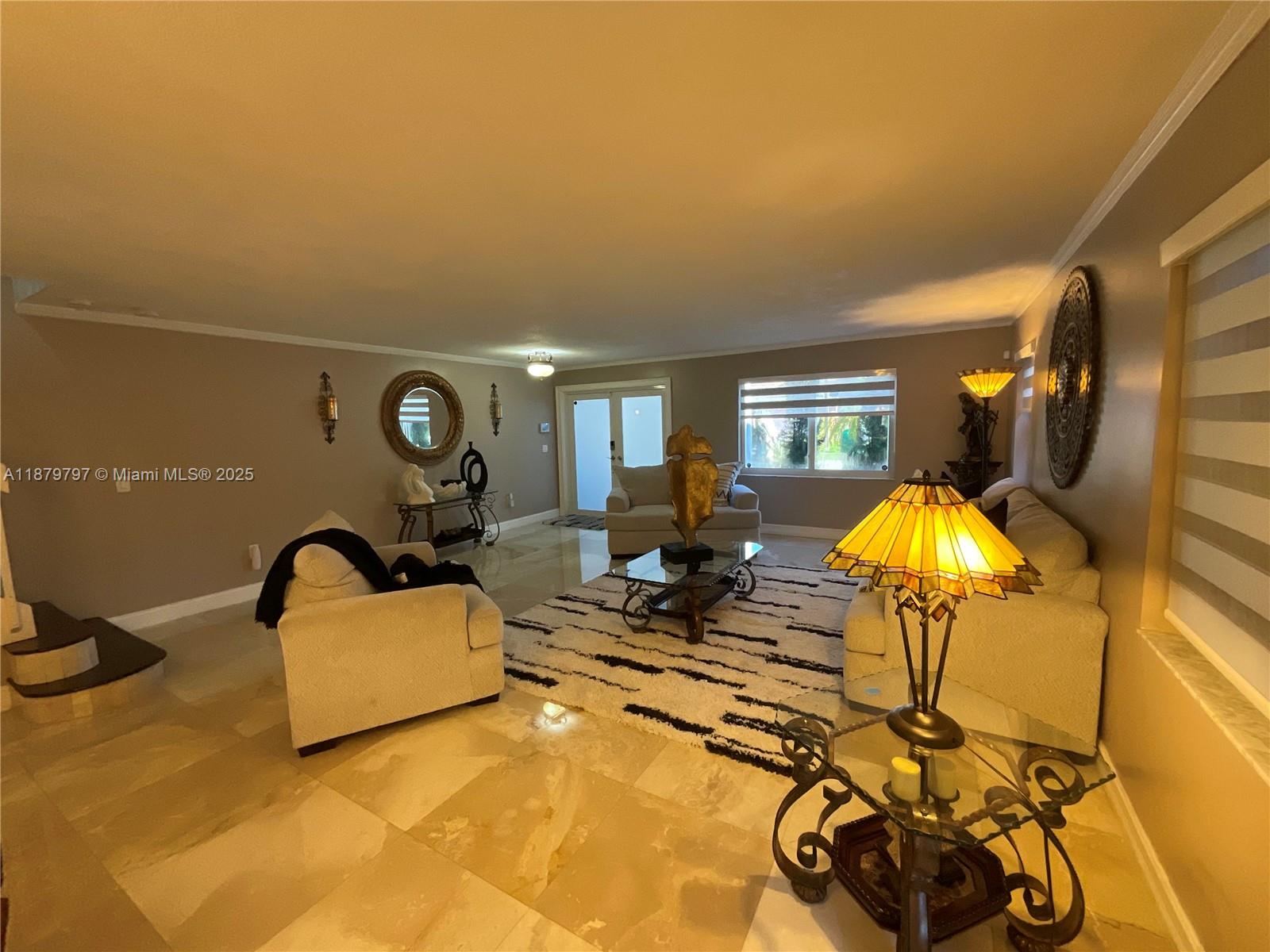 9710 Southwest 13th Street, Unit 9710 Pembroke Pines, FL 33025 - Photo 3 of 43 a living room with furniture and a lamp