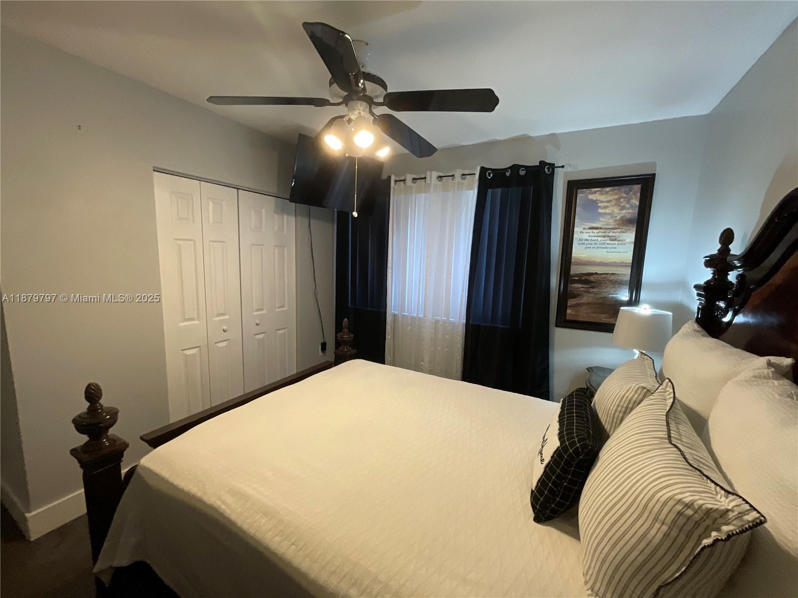 9710 Southwest 13th Street, Unit 9710 Pembroke Pines, FL 33025 - Photo 31 of 43 a bed room with a bed and a chandelier