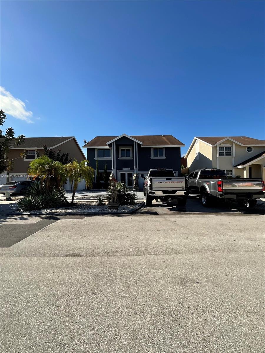 9710 Southwest 13th Street, Unit 9710 Pembroke Pines, FL 33025 - Photo 41 of 43 a car parked in front of a house