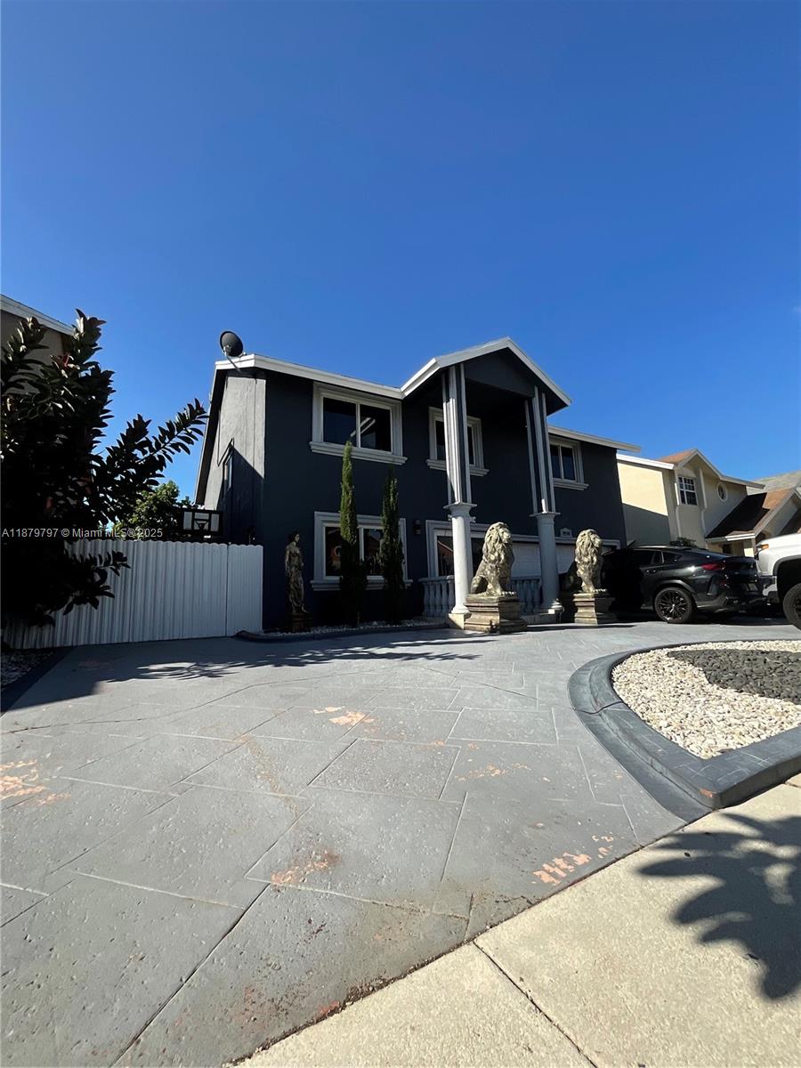 9710 Southwest 13th Street, Unit 9710 Pembroke Pines, FL 33025 - Photo 42 of 43 a front view of a house with yard