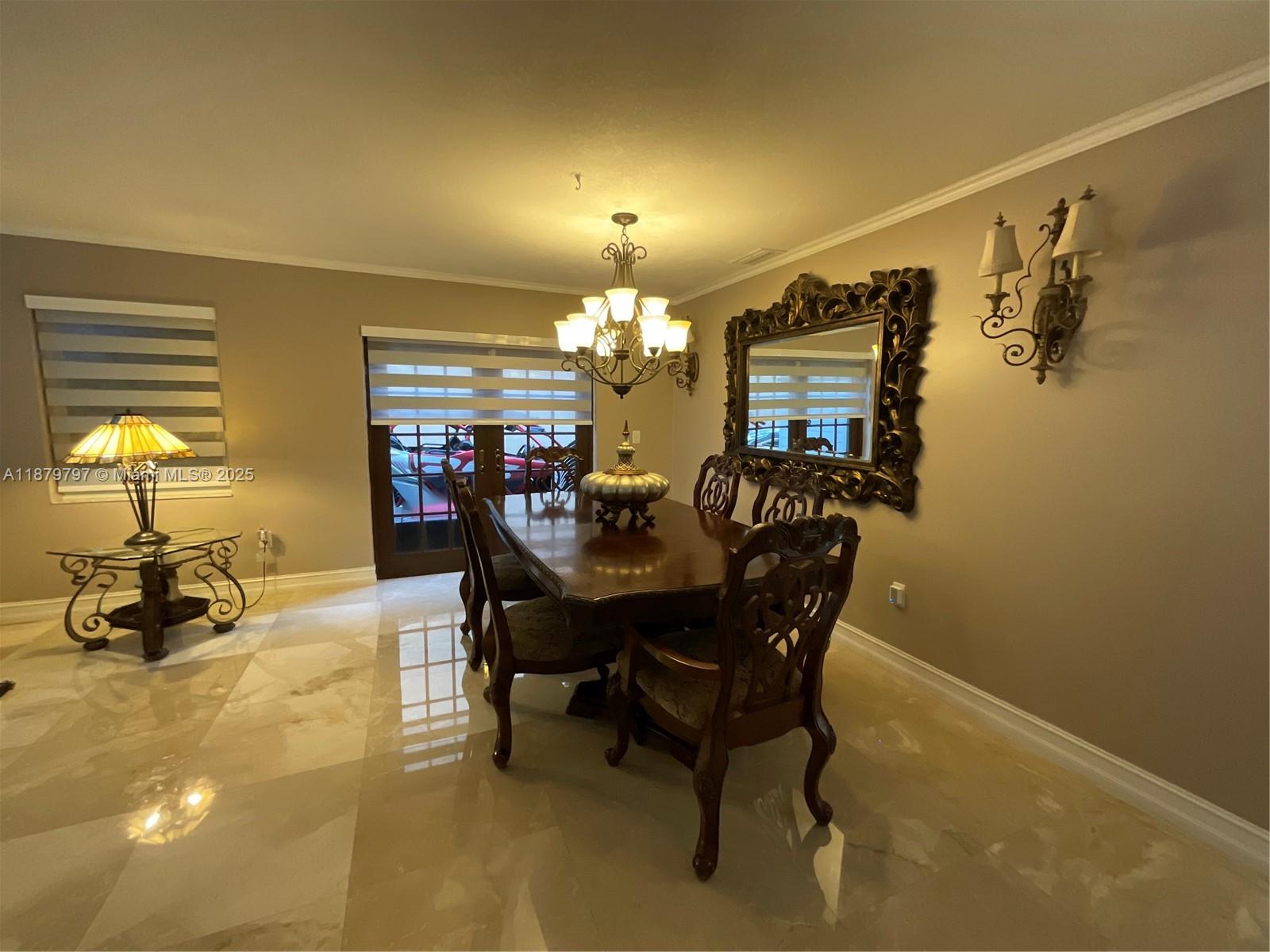 9710 Southwest 13th Street, Unit 9710 Pembroke Pines, FL 33025 - Photo 5 of 43 a view of a dining room with furniture and chandelier