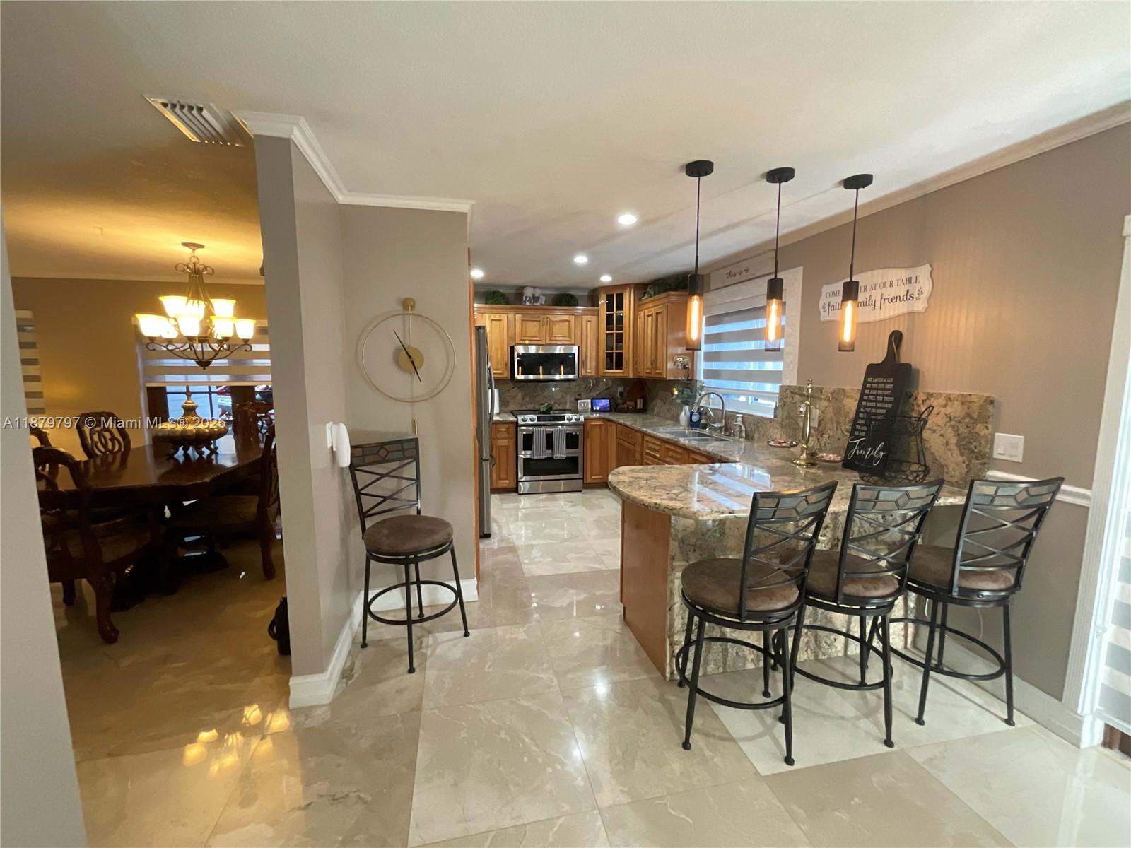 9710 Southwest 13th Street, Unit 9710 Pembroke Pines, FL 33025 - Photo 8 of 43 a living room with furniture and kitchen view