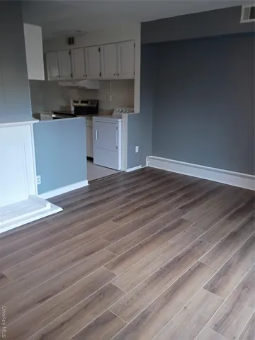 a kitchen with stainless steel appliances wooden floor and cabinets