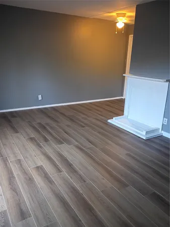 a view of a room with wooden floor