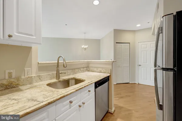 a kitchen with a refrigerator sink and microwave