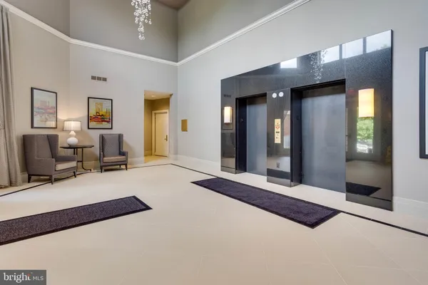 a bedroom with a bed couch and a large window