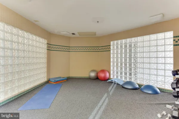 a kitchen with a dining table chairs and a refrigerator