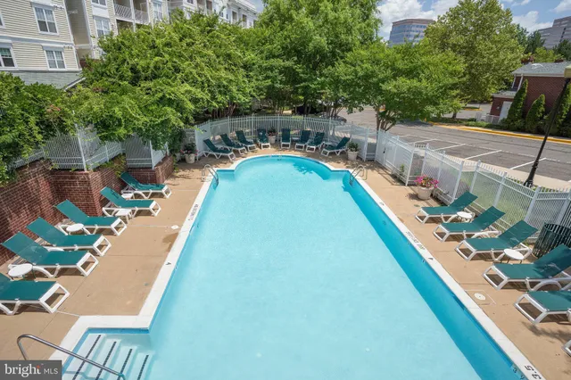 a kitchen with a dining table chairs and a refrigerator