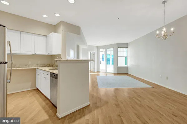 a kitchen with granite countertop a sink stove and cabinets