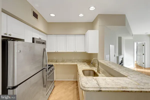 a kitchen with a sink and a refrigerator