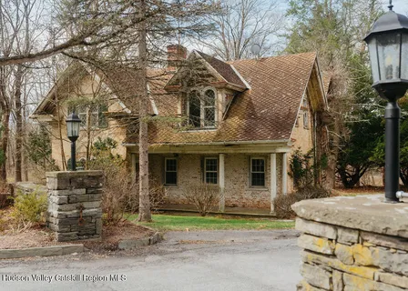 a view of house with a yard