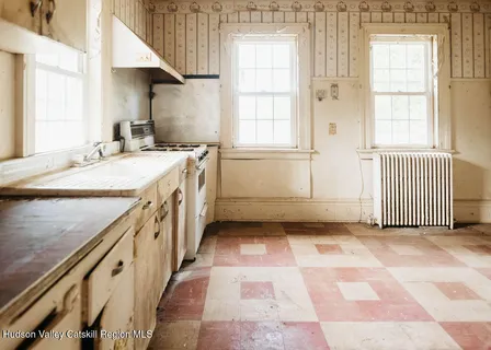 a bathroom with a sink a toilet and a window