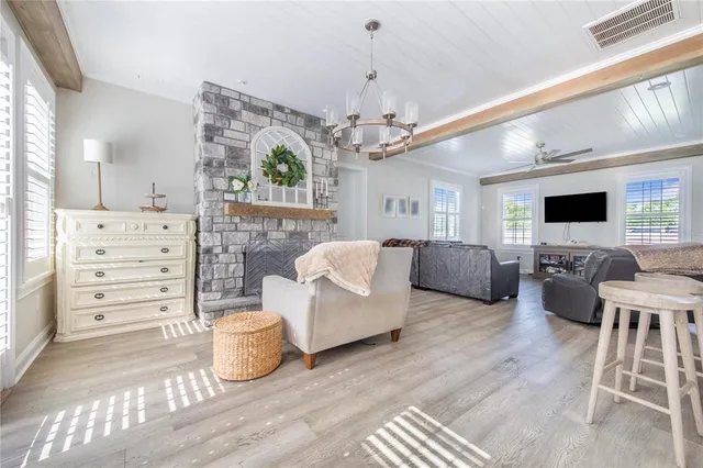 a bathroom with a granite countertop tub a double vanity sink and a large mirror