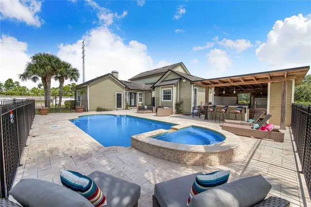 an aerial view of a house with swimming pool garden and patio