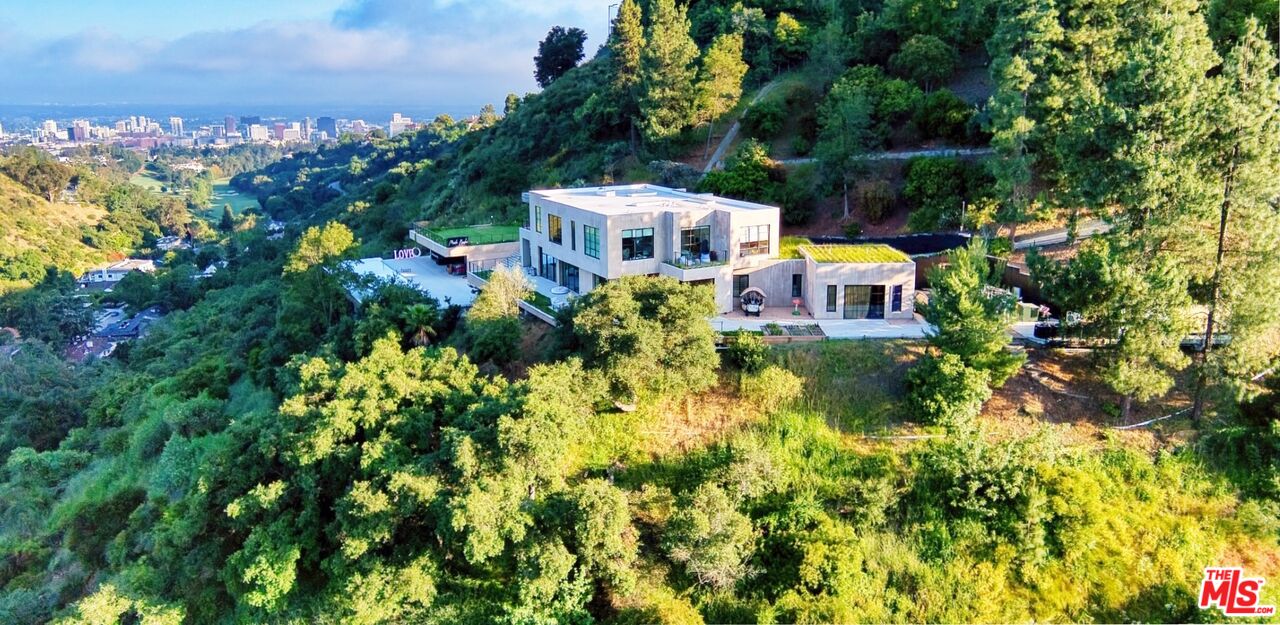 a aerial view of a house with a yard basket ball court and outdoor seating