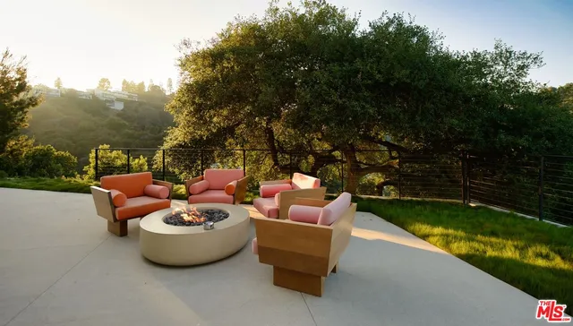 a view of a backyard with sitting area and garden