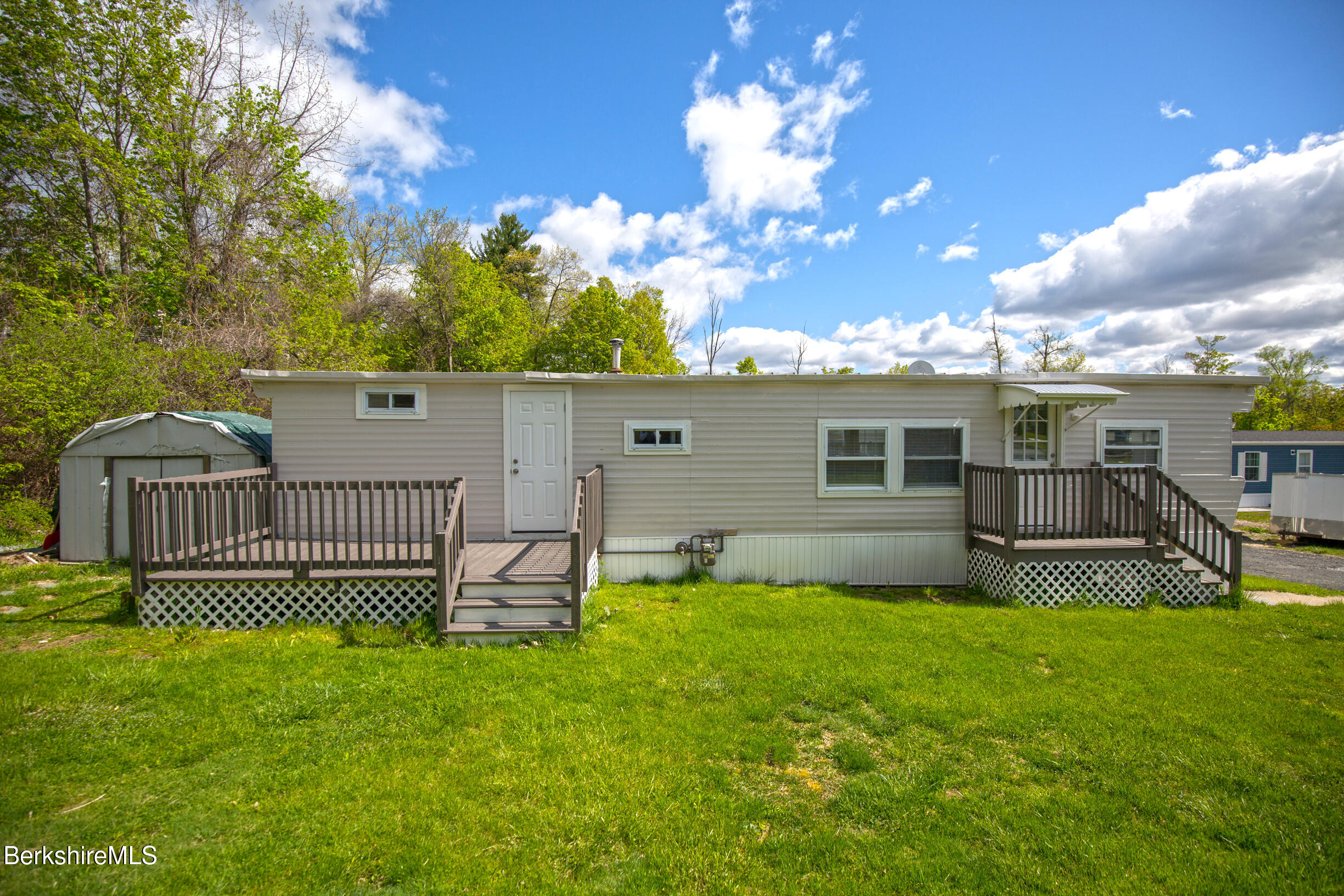 405 Pittsfield Road, Unit LOT F2 Lenox, MA 01240 - Photo 14 of 23 a front view of a house with a garden and yard