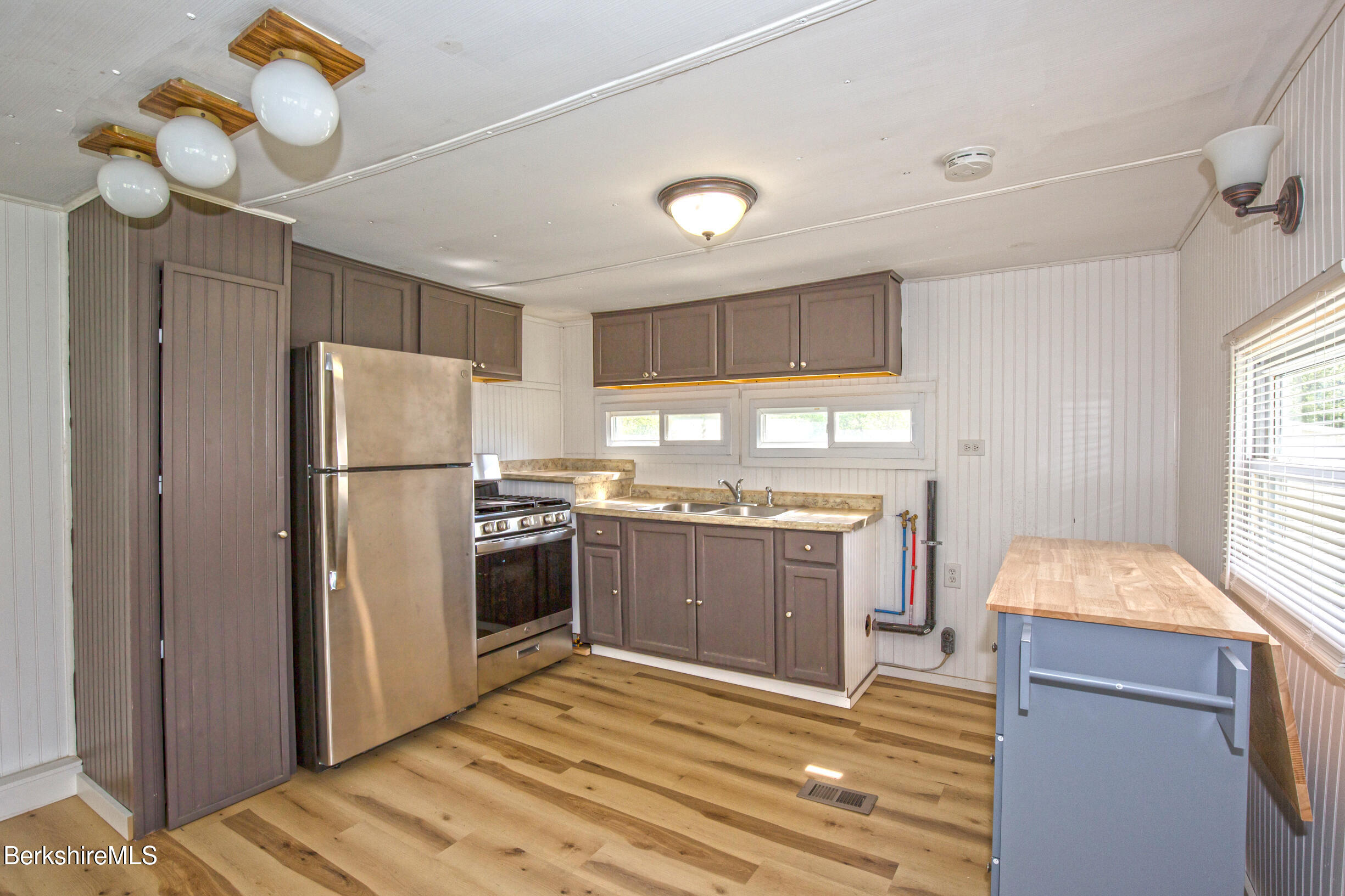 405 Pittsfield Road, Unit LOT F2 Lenox, MA 01240 - Photo 2 of 23 a kitchen with a refrigerator sink and cabinets