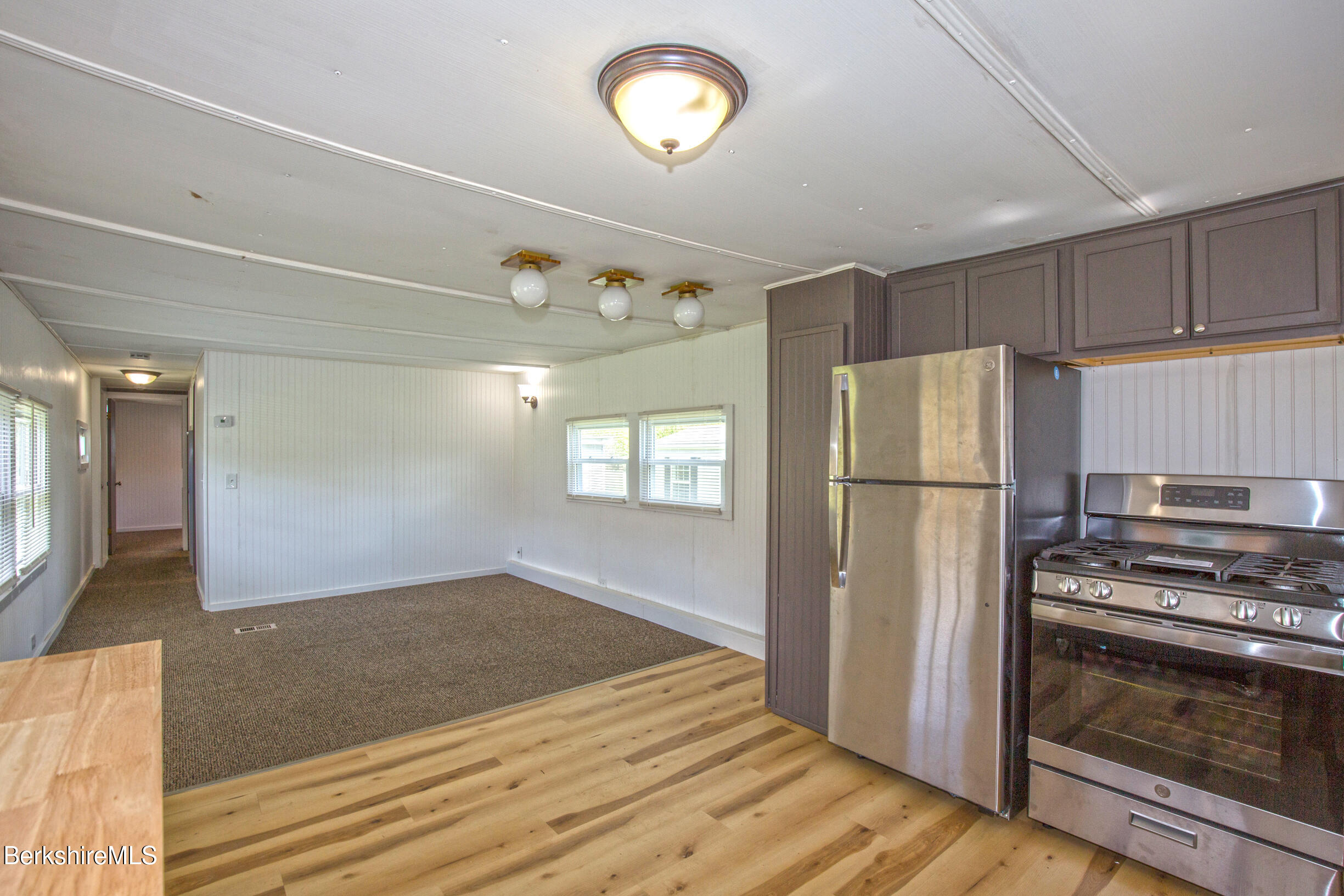 405 Pittsfield Road, Unit LOT F2 Lenox, MA 01240 - Photo 3 of 23 a kitchen with a refrigerator and a stove top oven