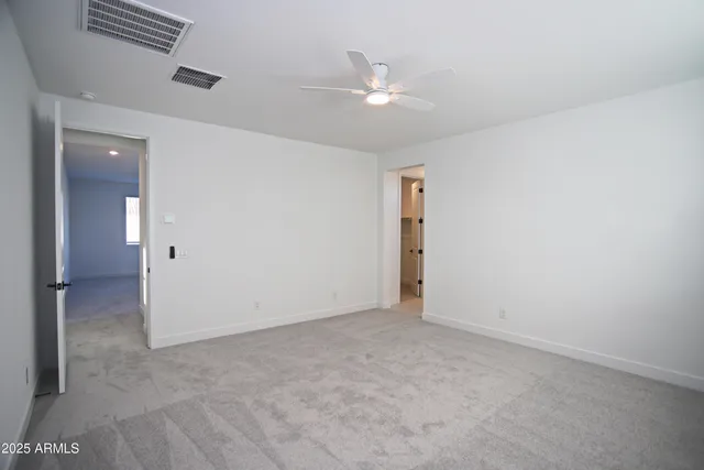 a view of walk in closet with empty racks
