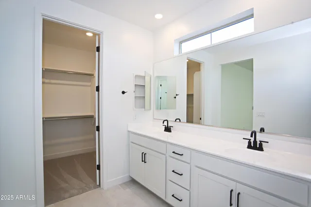 an empty room with a window and a ceiling fan