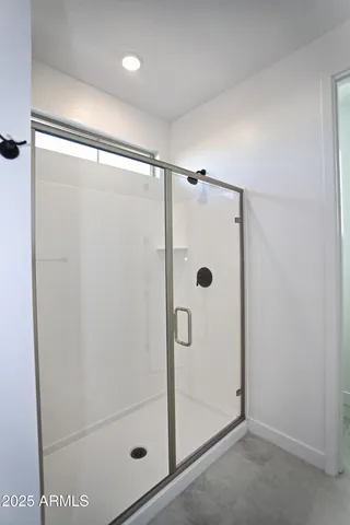 an empty room with a ceiling fan and a mirror