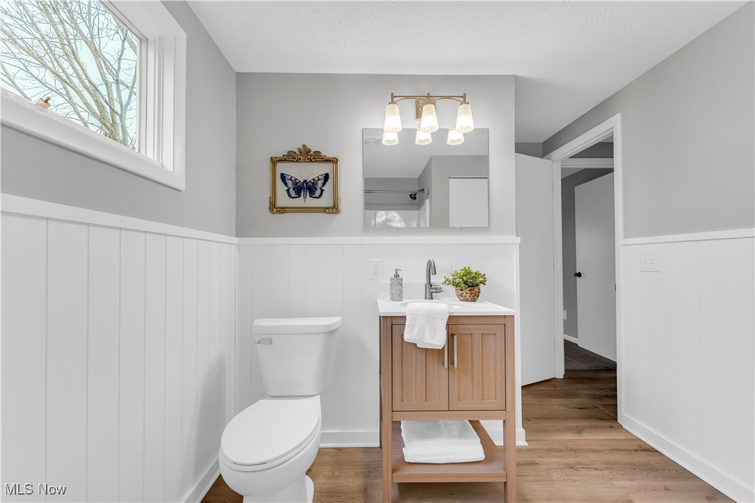 6920 Joppa Road Vermilion, OH 44089 - Photo 29 of 38 Bathroom with hardwood / wood-style floors, vanity, and toilet