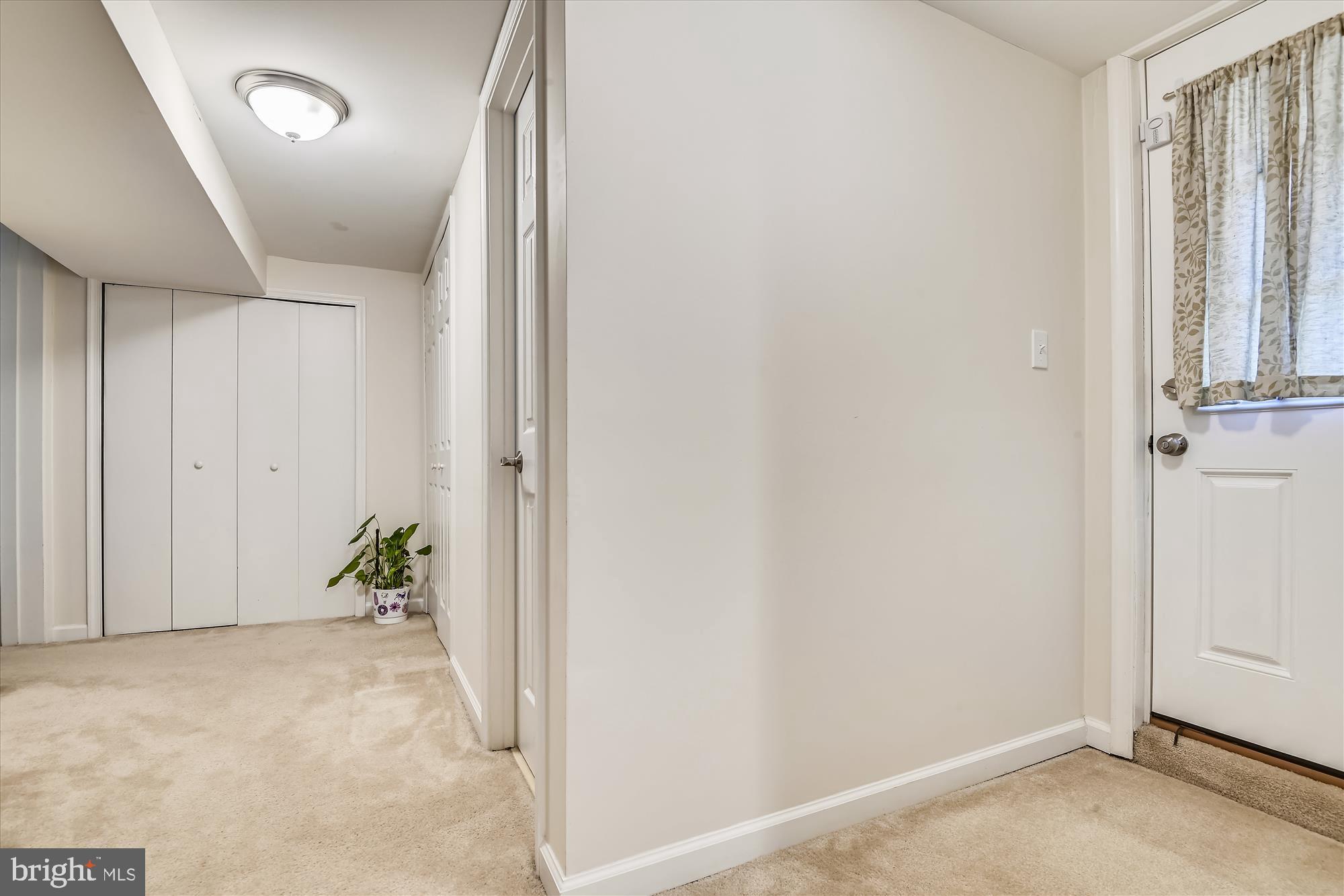 6805 Barnett Road Baltimore, MD 21239 - Photo 29 of 37 Basement hall, exit door on the right