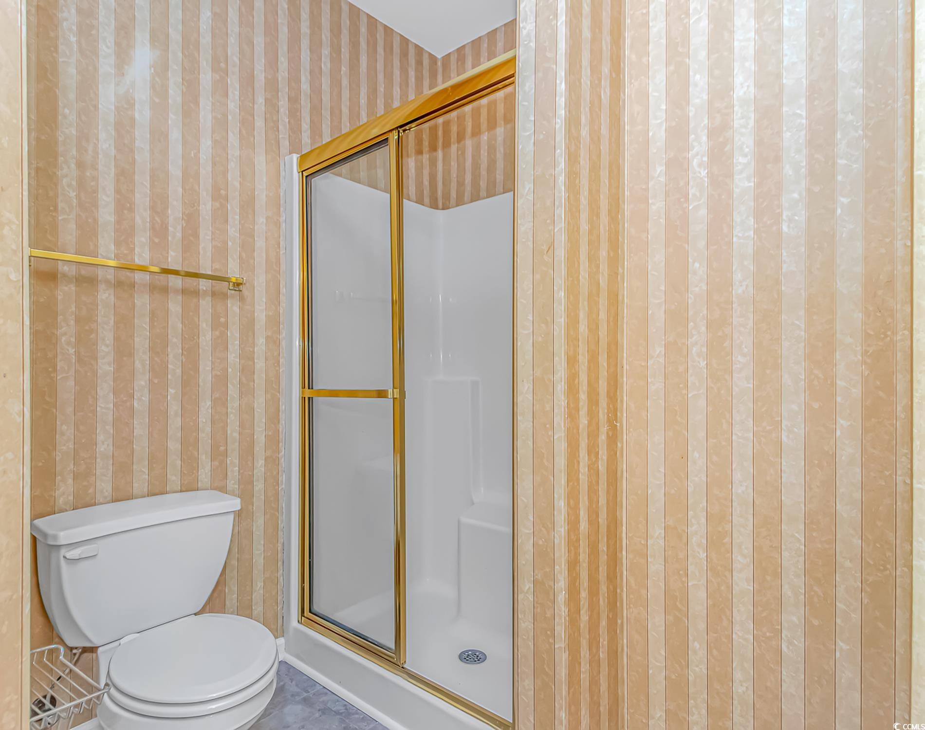 4814 Innisbrook Court, Unit 407 Myrtle Beach, SC 29579 - Photo 18 of 31 Full bath with wallpapered walls and a shower stall