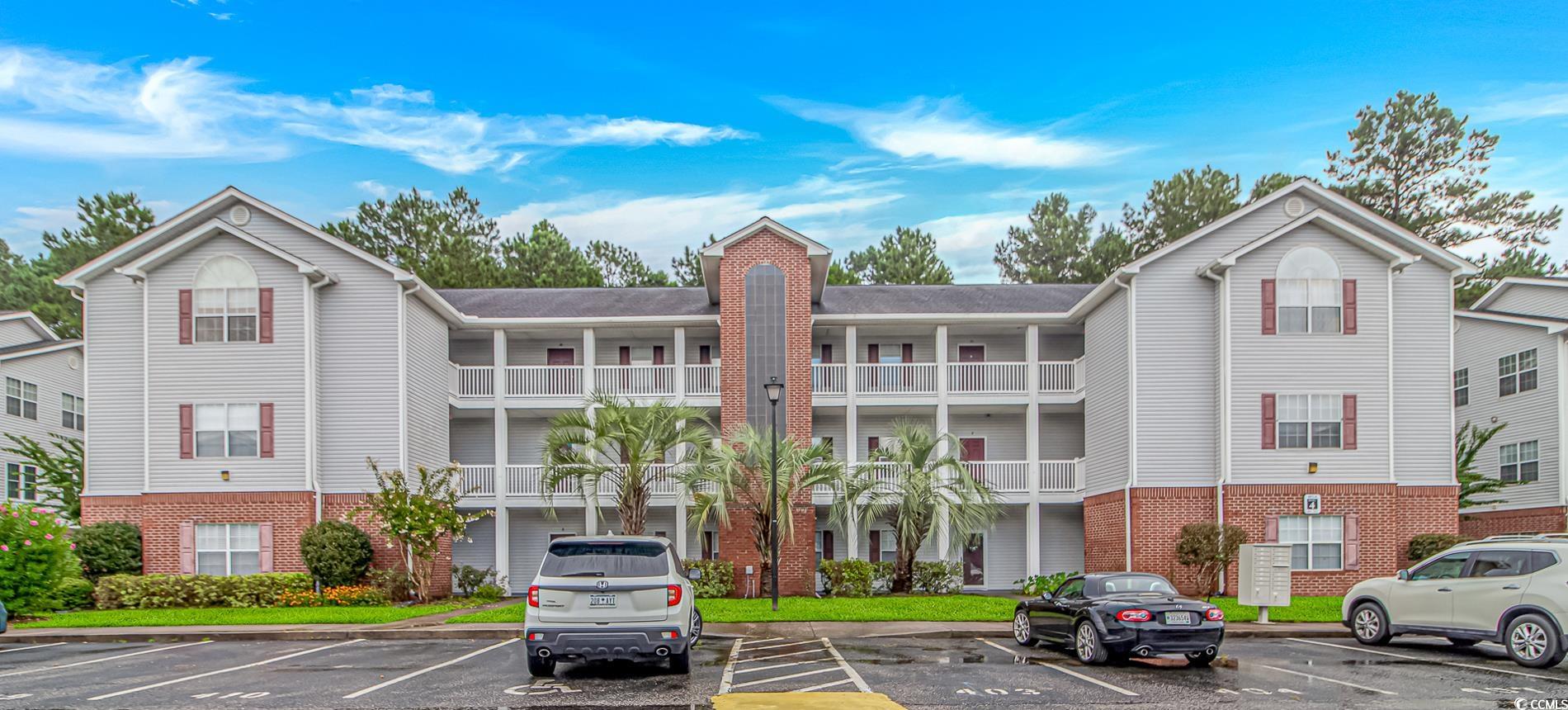 4814 Innisbrook Court, Unit 407 Myrtle Beach, SC 29579 - Photo 2 of 31 View of apartment building / complex featuring uncovered parking