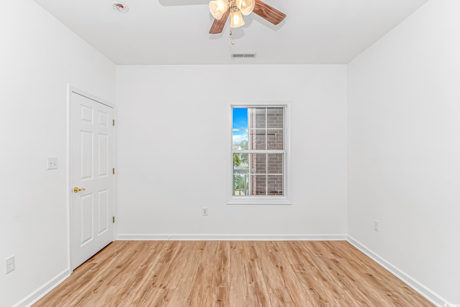 4814 Innisbrook Court, Unit 407 Myrtle Beach, SC 29579 - Photo 22 of 31 Empty room with light wood finished floors and a ceiling fan