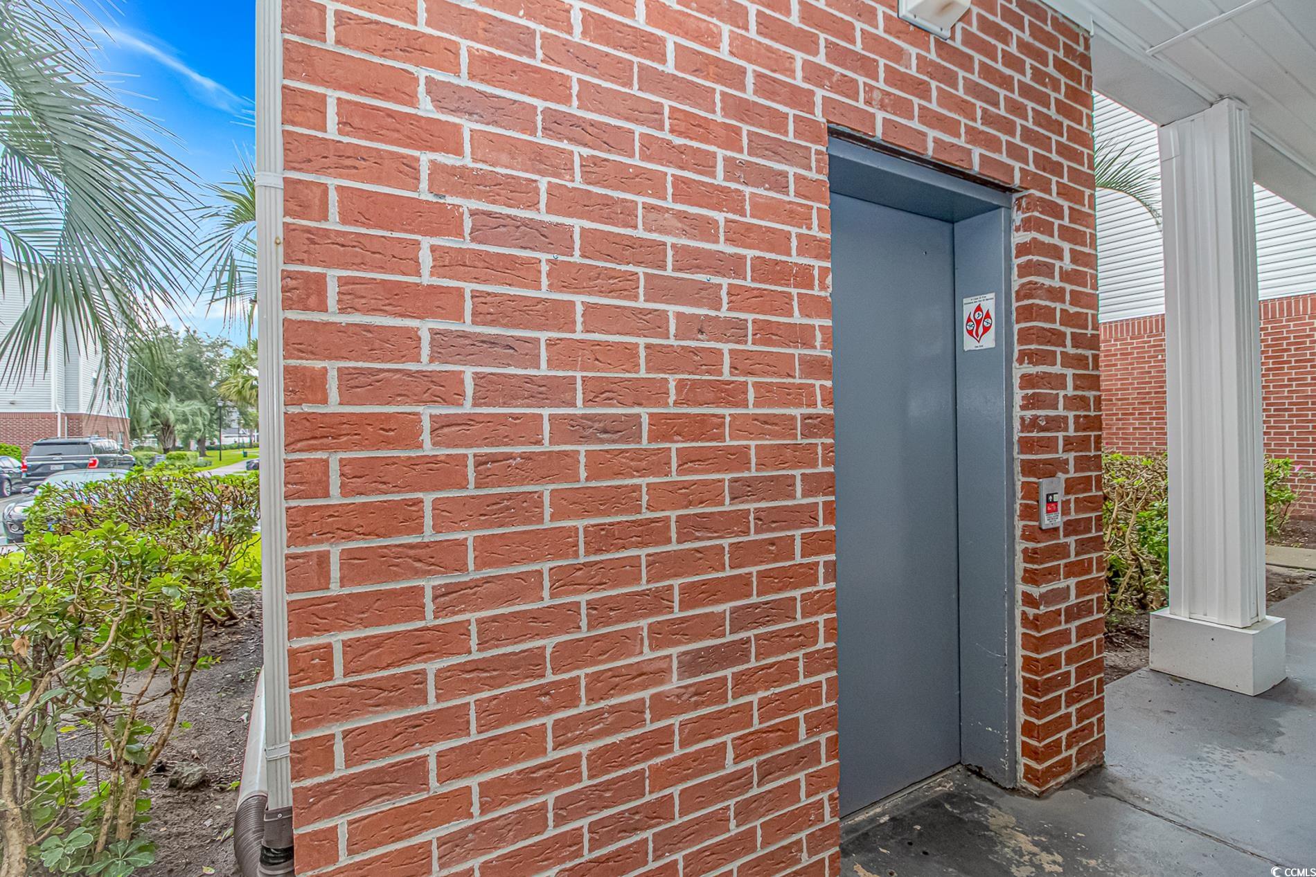4814 Innisbrook Court, Unit 407 Myrtle Beach, SC 29579 - Photo 3 of 31 Doorway to property with elevator and brick siding
