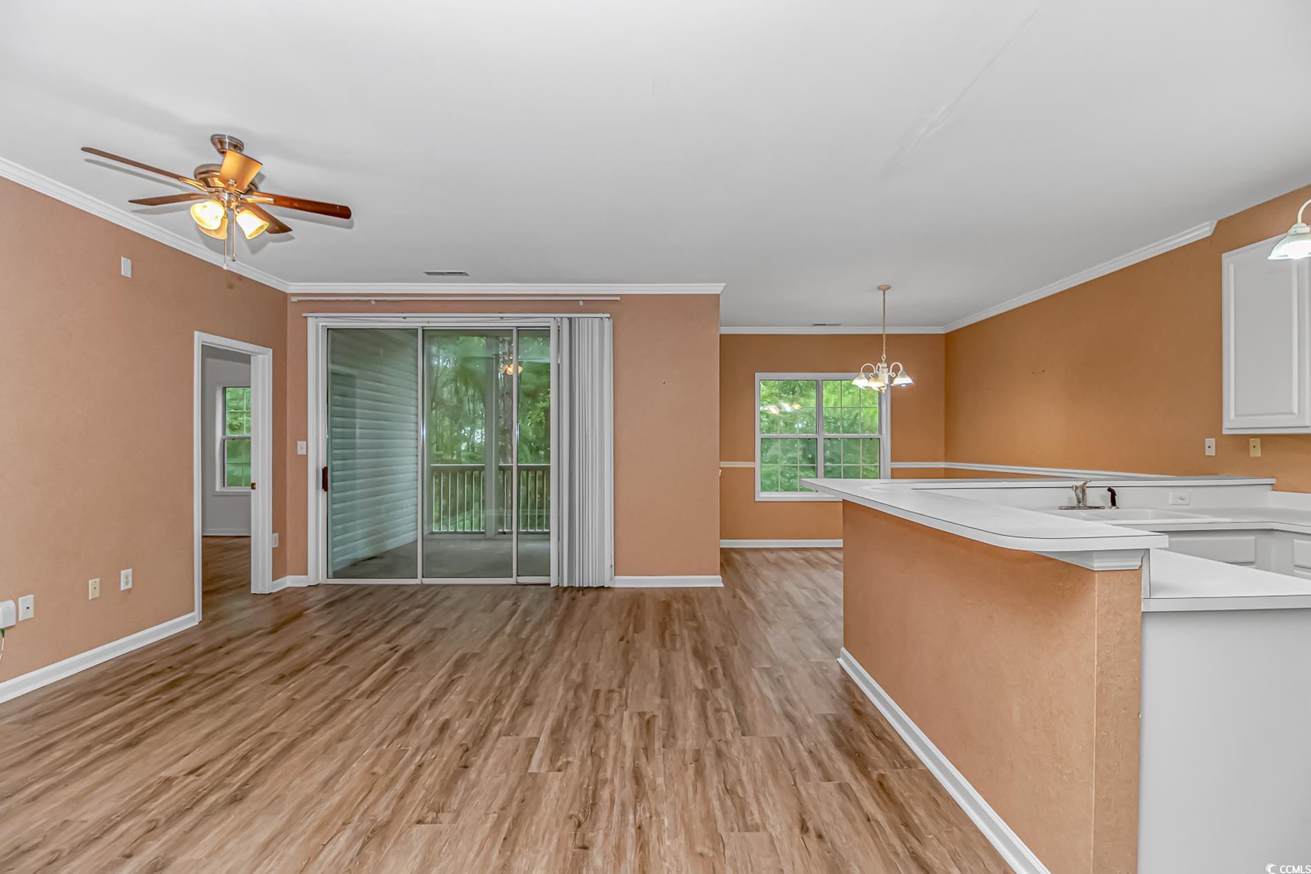 4814 Innisbrook Court, Unit 407 Myrtle Beach, SC 29579 - Photo 5 of 31 Kitchen featuring light countertops, decorative light fixtures, crown molding, a peninsula, and a chandelier