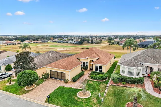 an aerial view of residential houses with outdoor space and swimming pool