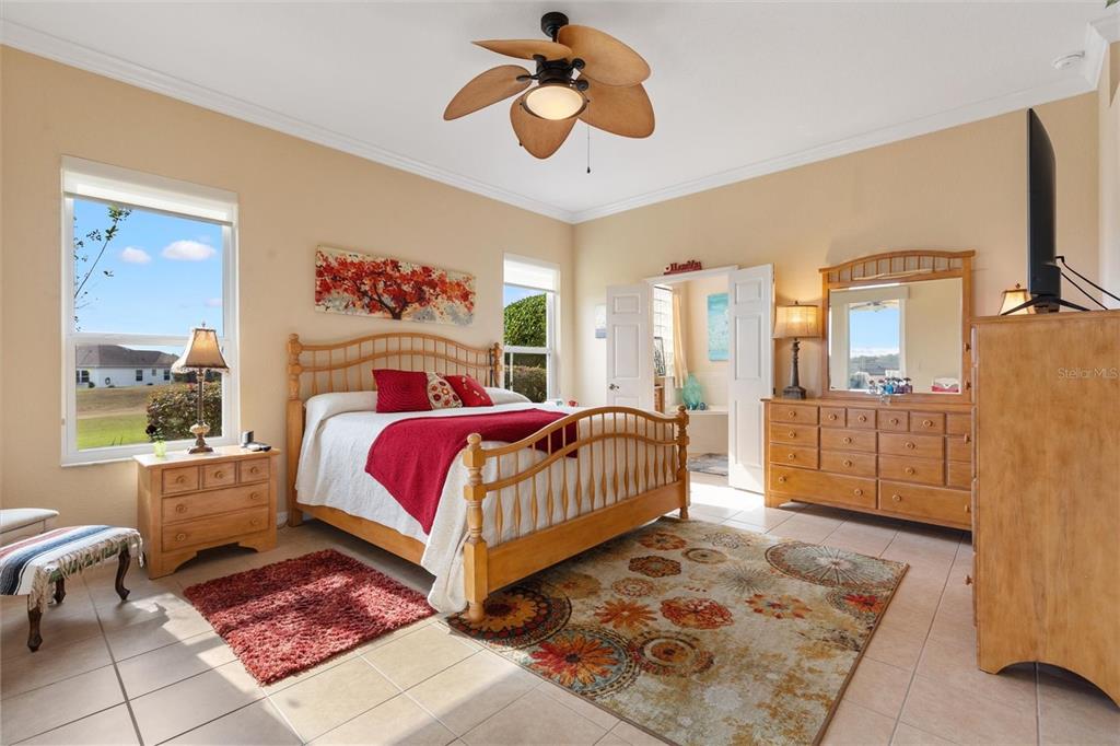 17031 Southeast 115th Terrace Road Summerfield, FL 34491 - Photo 18 of 54 a bedroom with a bed rug and window