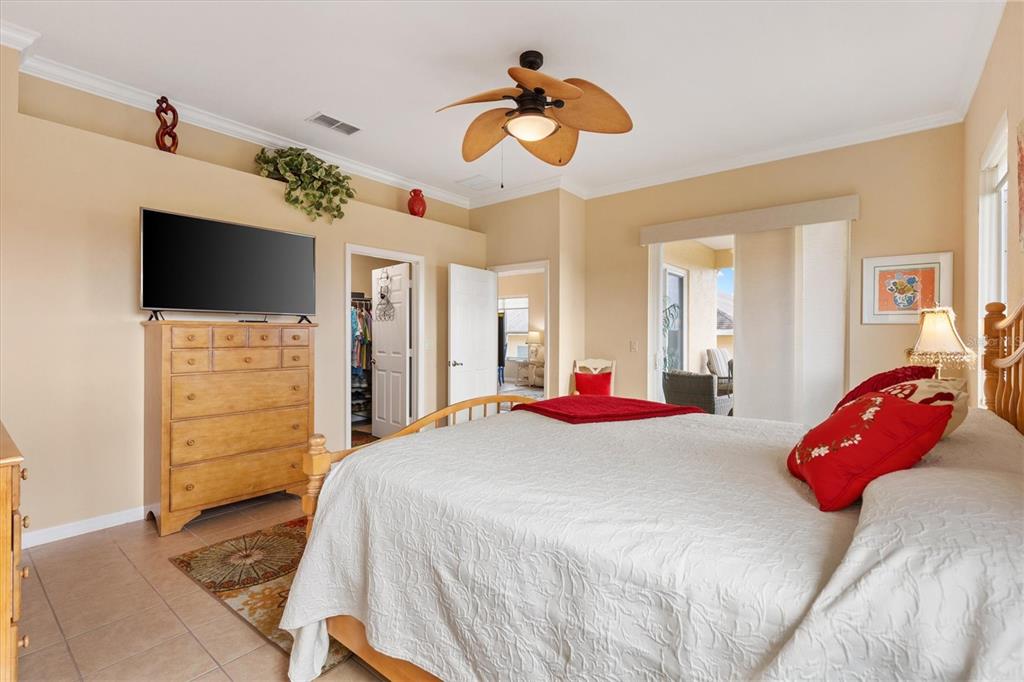 17031 Southeast 115th Terrace Road Summerfield, FL 34491 - Photo 19 of 54 a bedroom with a bed and a flat tv screen on dresser