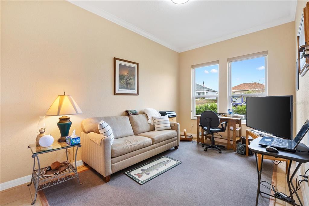 17031 Southeast 115th Terrace Road Summerfield, FL 34491 - Photo 25 of 54 a living room with furniture and a flat screen tv