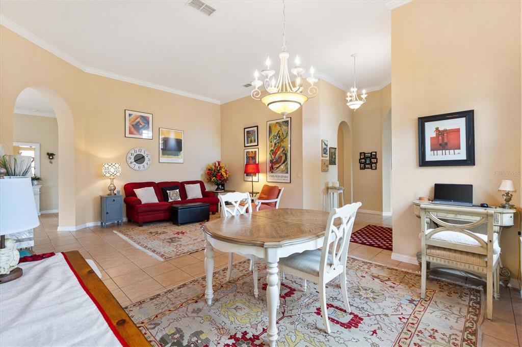 17031 Southeast 115th Terrace Road Summerfield, FL 34491 - Photo 8 of 54 a living room with fireplace furniture and a chandelier