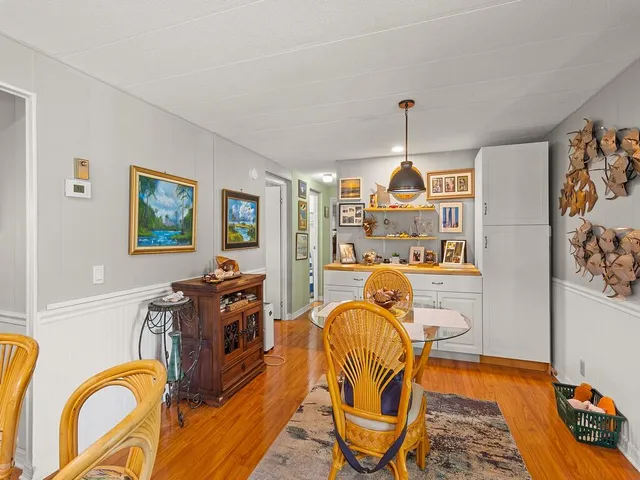 a bedroom with filled bed and furniture
