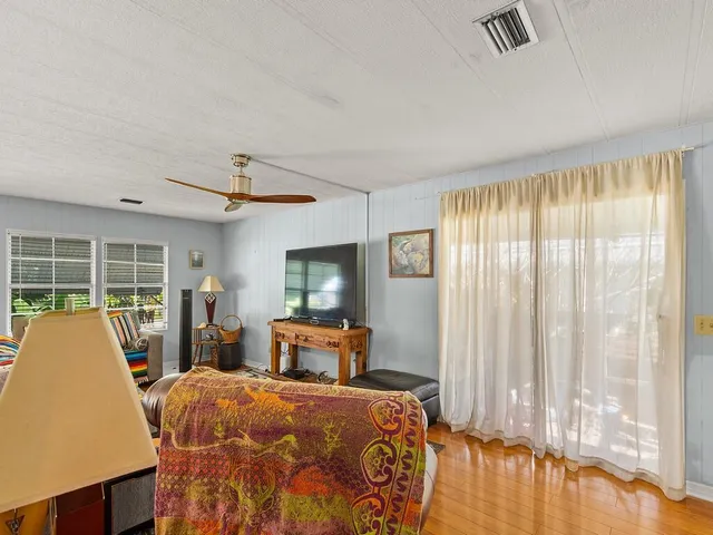 a bedroom with a large bed and a large window