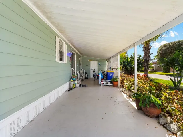 a view of a patio with table and chairs and potted plants
