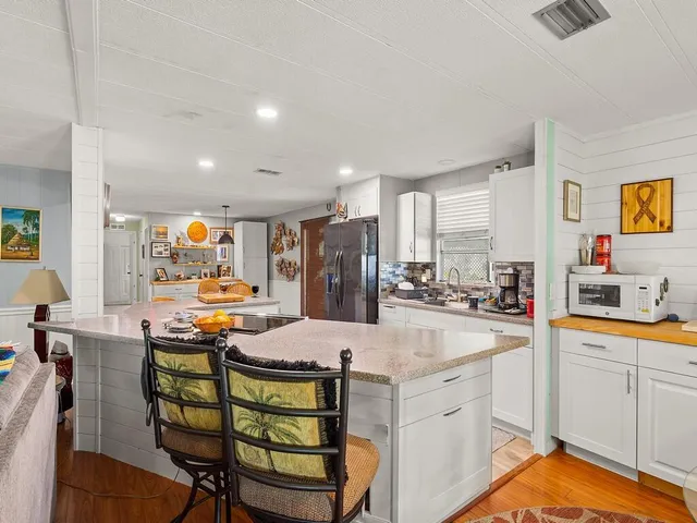 a large kitchen with a table and chairs in it