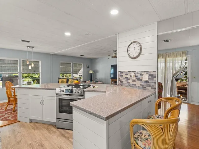 a kitchen with a stove a refrigerator and a sink