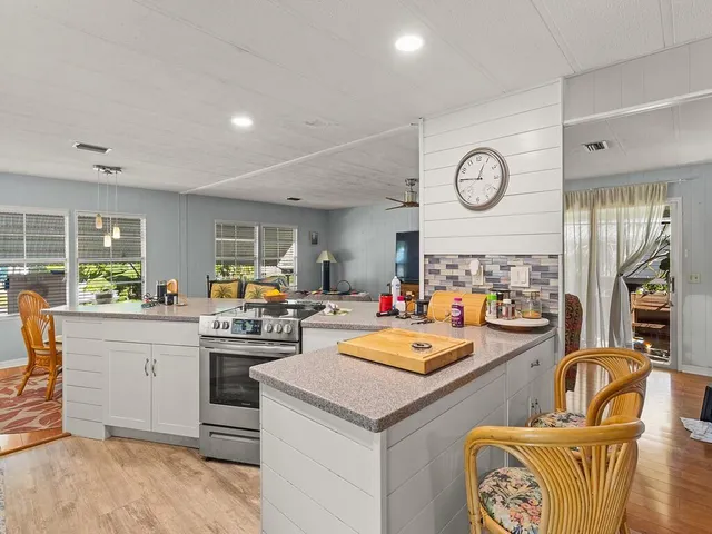a kitchen with sink refrigerator and stove top oven
