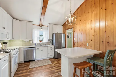 a kitchen with a sink cabinets and wooden floor