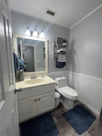 a bathroom with a toilet sink and mirror